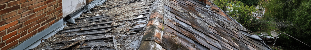 A badly damaged, old, soggy garage roof